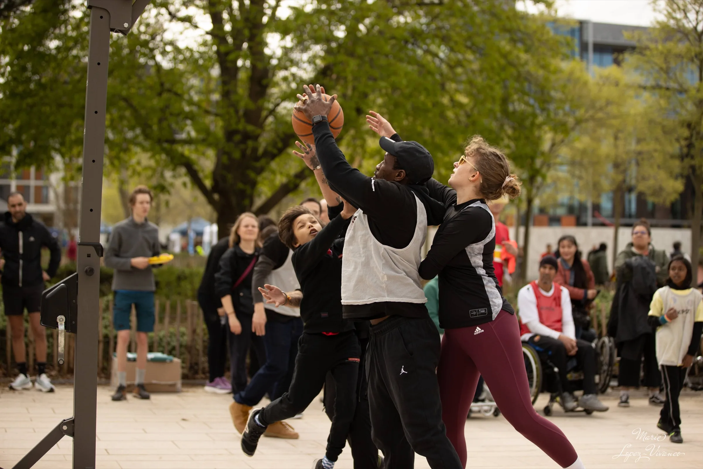 Des participantes et participants tentent d’attraper un ballon de basket lors d’une rencontre sportive.
